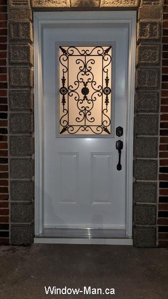 Front door. Half glass insert. Port Stanly wrought iron